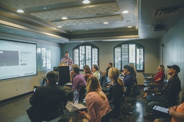 A small class watching an instructor give a presentation.